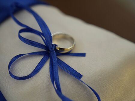 Wedding ring tied with a royal blue ribbonの写真素材