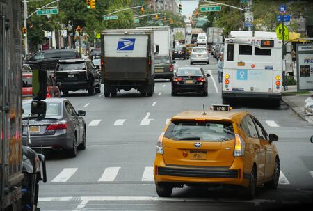 New York, USA- September 2017: A Yellow Cab joins the traffic flow at W 97th Street in New York...