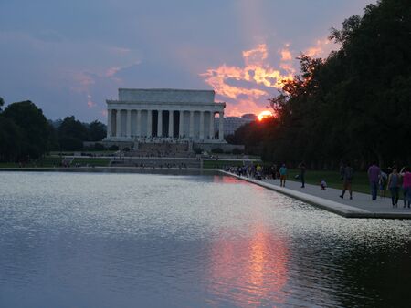 Washington, D.C., USA-September 2017: A beautiful sunset is seen behind the Lincoln Memorial, reflected in the waters of a pool in Washington, District of Columbia.のeditorial素材