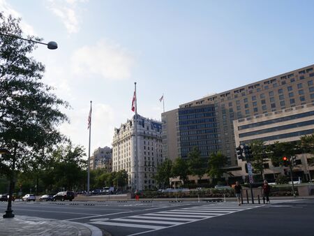Washington, D.C. USA- September 2017: Two people wait at the crosswalk infront of landmark buildings along Pennsylvania Avenue, Washington, District of Columbia.のeditorial素材