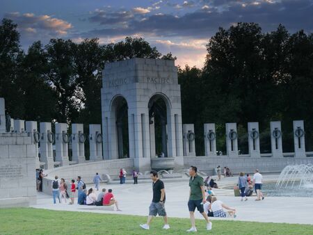 Washington, D.C., USA-September 2017: Visitors linger around the water fountains at the National World War 11 Memorial at sunset in Washington, District of Columbia.のeditorial素材