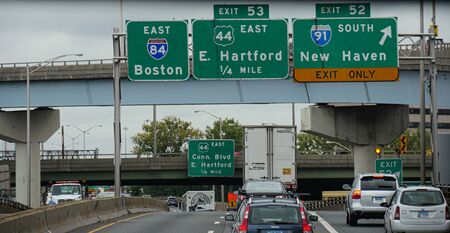 Boston, Massachusetts- September 2017: Close up of directional signs on Interstate 84 with directions to Boston, Hartford and New Haven.のeditorial素材
