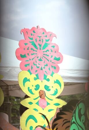 Davao City, Philippines-August 2014: A street dancing participant hides behind a colorful prop at the parade. Kadayawan is celebrated August each year to give thanks for life and an abundant harvest.のeditorial素材