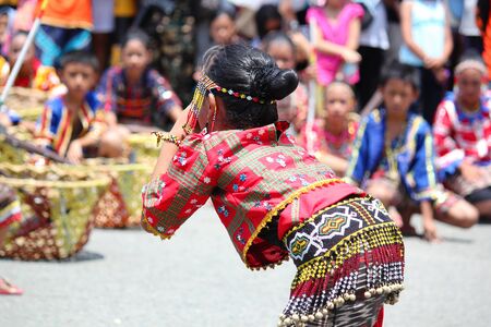 Davao City, Philippines-August 2014: Back view of a parade participant in colorful costume at the streetdancing competition. Kadayawan is celebrated August each year to give thanks for life and an abundant harvest.のeditorial素材