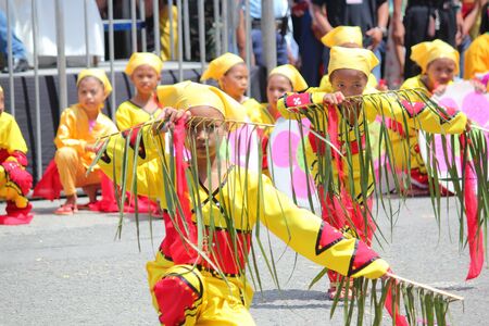 Davao City, Philippines-August 2014: Street dancers perform using coconut fronds. Kadayawan is celebrated August each year to give thanks for life and an abundant harvest.のeditorial素材