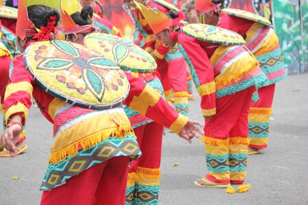 Davao City, Philippines-August 2014: Back view of the colorful costumes of streetdancing participants. Kadayawan is celebrated August each year to give thanks for life and an abundant harvest.のeditorial素材