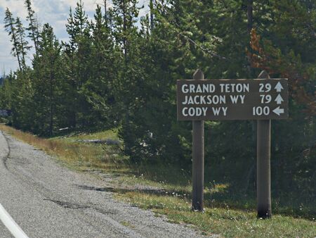Directional sign on the roadside to the Grand Teton, Jackson and Cody, Wyoming.の写真素材