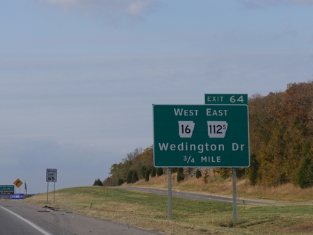 Roadside signs and directions to Wedington Drive along Interstate 49 in Arkansas.のeditorial素材