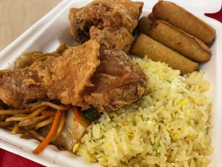 Close up of a complete fried chicken meal with fried rice, noodles and spring rolls.の写真素材