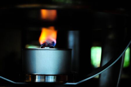 Hot dancing flames from a burner, dark background