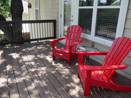 Wide comfortable red wooden seats in the balcony of a structure