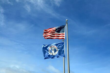Flag of the United States and the Commonwealth of the Mariana Islands, wide blue skies in the...