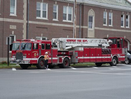 Newport, Rhode Island-September 2017: Newport Fire Department firetruck parks at a curbside, with a...