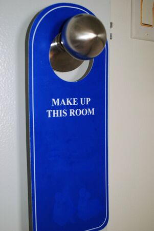 Blue door hanger for housekeeping to make up roomの写真素材
