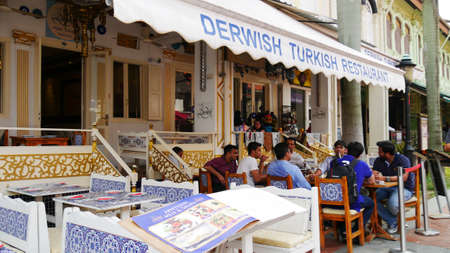 Singapore, Singapore-March 2016: People sitting on a table outside a Derwish Turkish restaurant in Kampong Glam, Singapore.のeditorial素材