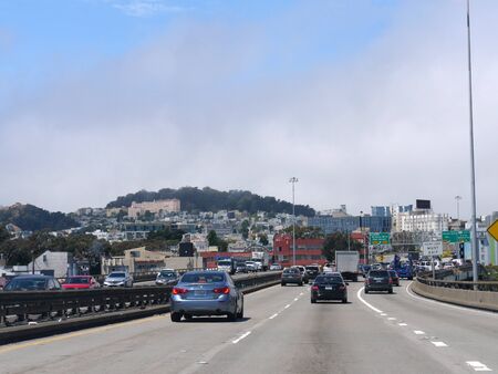 San Francisco, California-July 2018: Cars on the road with San Francisco buildings in the background
