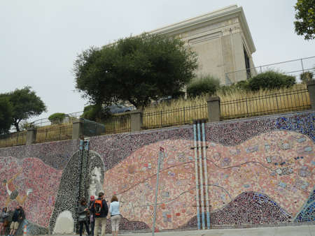 San Francisco, California-July 2018: People standing along a colorful wall with art designs in San Francisco.のeditorial素材