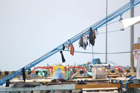 Surigao del Sur, Philippines- August 2014: Ropes with clothes hanging to dry in a fishing vessel...