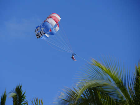 Fort Lauderdale, Miami- December 2018: A blue parasail flies above the trees over Fort Lauderdale beach.のeditorial素材