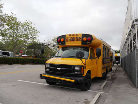 Fort Lauderdale, Miami- December 2018: A yellow school bus in the parking lot of a school.