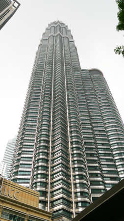 Kuala Lumpur, Malaysia- March 2018: Upward shot of one of the Twin Petronas Towers in Kuala Lumpur,...