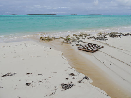 Wooden raft lying in the pristine white sand shores of a tropical beachの写真素材