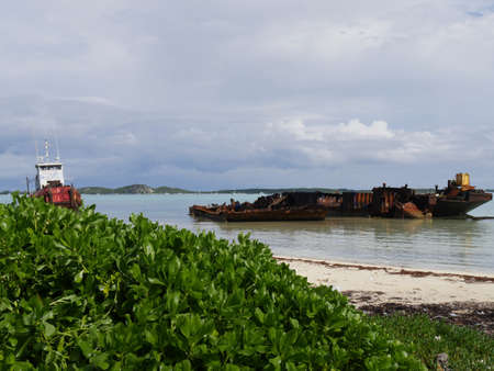 Rusty scraps from a shipwrecked fishing by the shores of a beach in George Town, Bahamasの写真素材