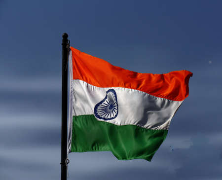 Close up of an unfurled flag of India waving  from a poleの写真素材