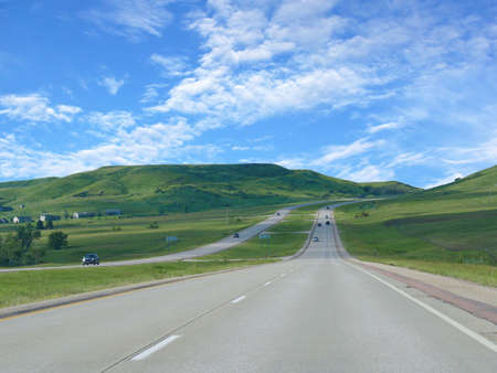 Interstate highway with rolling mountains in South Dakota.の写真素材