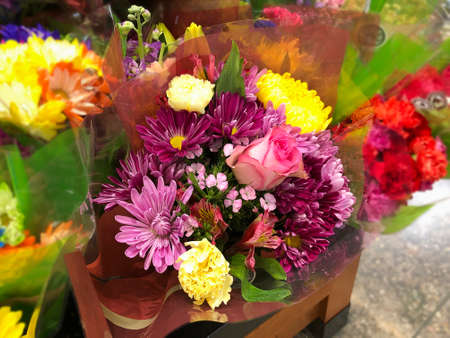 Assorted flowers in a bouquet wrapped in plasticの写真素材