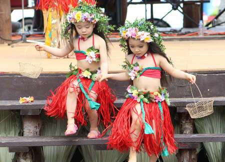 TINIAN, CNMI-USAâTwo little girls dressed up as island cultural dancer costumes go down wooden stairs at the Pika Festival in February 2015.のeditorial素材