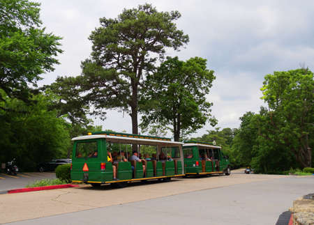 EUREKA SPRINGS, ARKANSASâA green tram tours trolley with passengers runs around the historic district of of Eureka Springs. Taken in May 2017.のeditorial素材