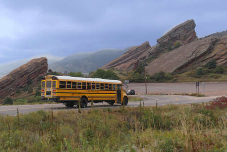 MORRISON, COLORADOâOCTOBER 2017: A Denver Public Schools bus travelling on the road to the Red Rocks Park and Ampitheatre in Morrison for a school field trip.のeditorial素材