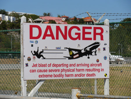 ST. MARTIN, CARIBBEAN ISLANDSâMARCH 2017: Sign outside the wire fence of the Princess Juliana International Airport next to Maho Beach, Dutch side of St. Martin.のeditorial素材