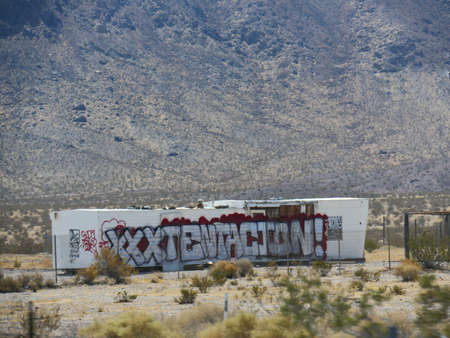 Beatty, Nevada-August 2018: Containers with huge graffiti seen from the roadside in Nevada.のeditorial素材