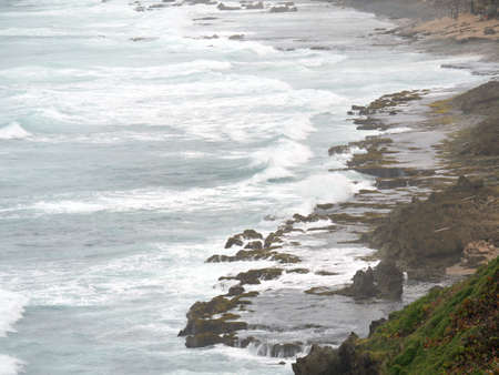 Coastal view with a rocky shoreline in a tropical islandの写真素材