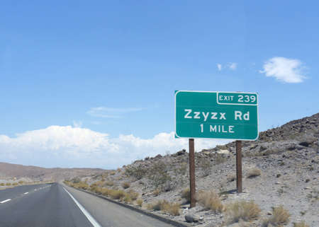 Roadside sign with distance and exit direction to ZZyzx Road along Interstate 15 in California.の写真素材