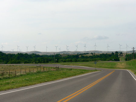 Wind turbines on a rural road in the United States of America.の写真素材