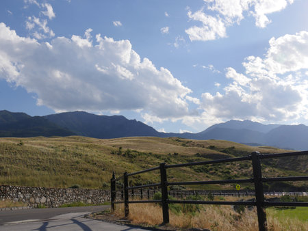 Winding road with fences on the sides in Gardiner, Montana.の写真素材