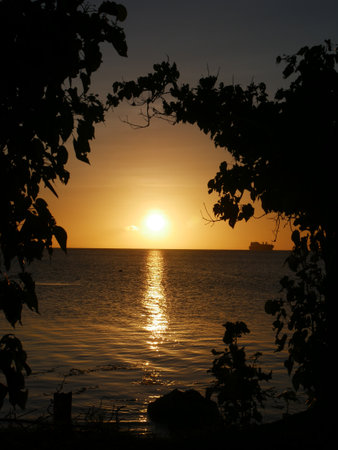 Beautiful sunset reflected in the water, portrait shotの写真素材