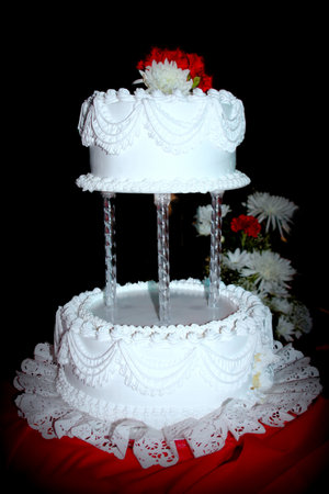 White wedding cake in two layers, with black background.の写真素材