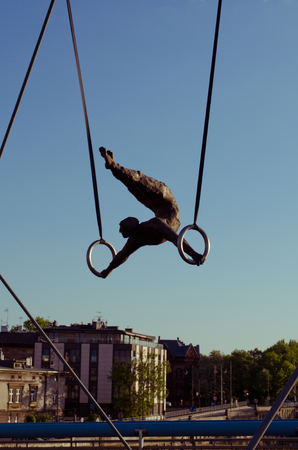 Krakow,Poland - May 12, 2018: Bridge in Krakow the K adka Ojca Bernatka or Father Bernatek Footbridge across the Vistula river, Krakow, Poland. Most artistic and quirky suspension bridge of Krakow. The acrobatic figures by Polish artist Jerzy Jotki Kedzioのeditorial素材