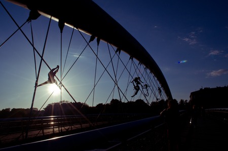 Krakow,Poland - May 12, 2018: Bridge in Krakow the K adka Ojca Bernatka or Father Bernatek Footbridge across the Vistula river, Krakow, Poland. Most artistic and quirky suspension bridge of Krakow. The acrobatic figures by Polish artist Jerzy Jotki Kedzioのeditorial素材