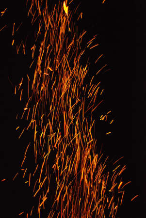 Fire sparks and red flame sparkles on black background