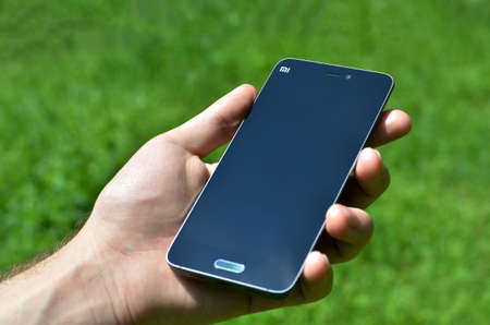 chinese Smartphone Xiaomi Mi 5 in male handのeditorial素材