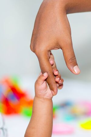 A asian baby's hand holding her mother fingerの写真素材