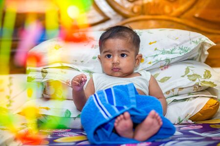 A asian baby boy is looking and playing at colorful toys.の写真素材