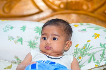 A asian baby boy is looking and playing at colorful toys.の写真素材