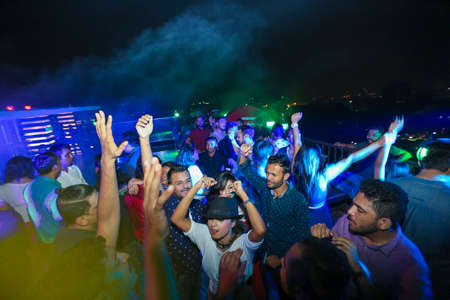 Bangladesh â€“ October 23, 2015: People dancing and enjoying DJ Party at Picasso Restaurant in...