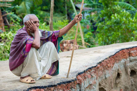 Bangladesh â June 27, 2015: An old man is showing where is his previous house was at Rasulpur, Barisal District.のeditorial素材
